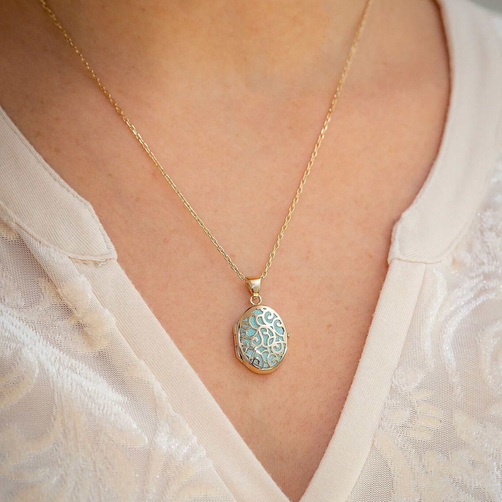 Cara Keepsakes Gold Locket Urns Gold Filigree Oval Locket Urn worn on model