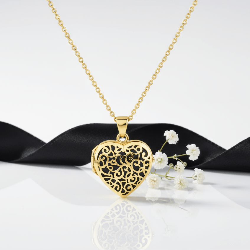 Gold_Heart_Filigree_Locket_Urn with flowers and a black ribbon