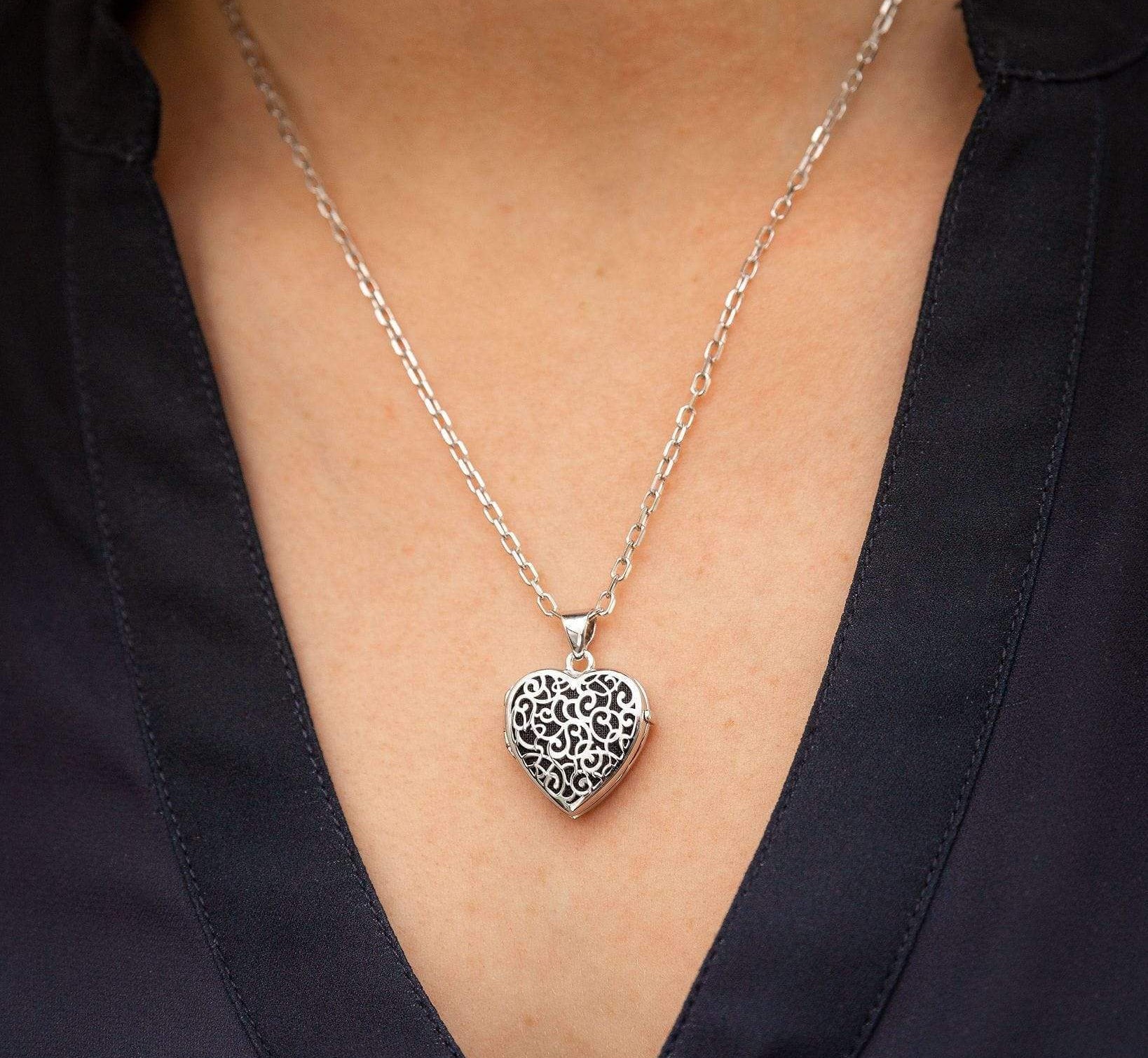 silver heart filigree locket urn on woman's neck