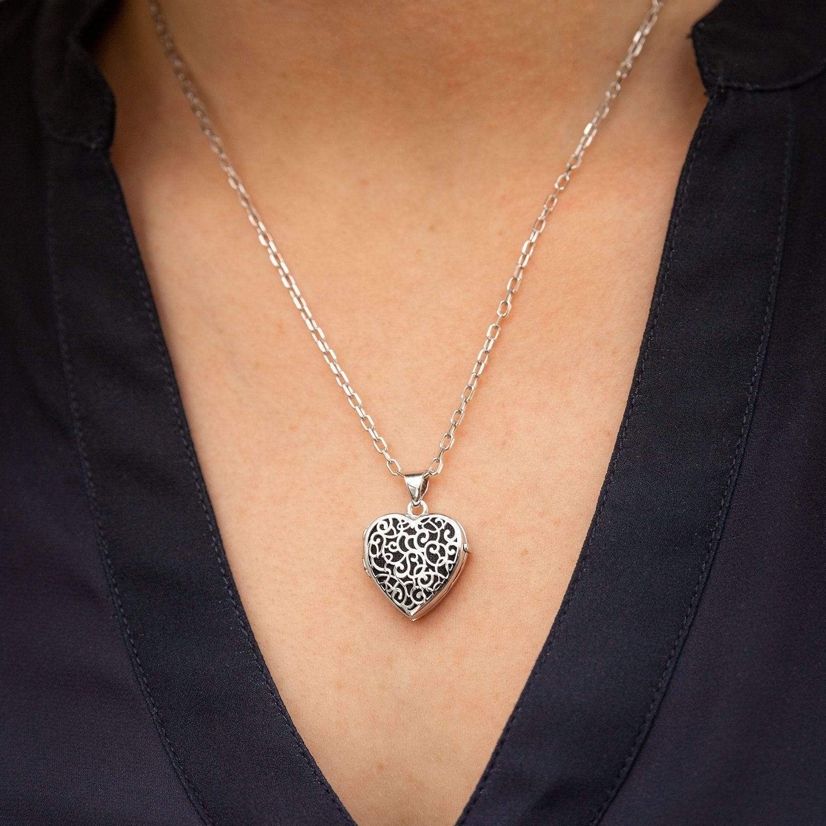 silver heart filigree locket urn on woman's neck